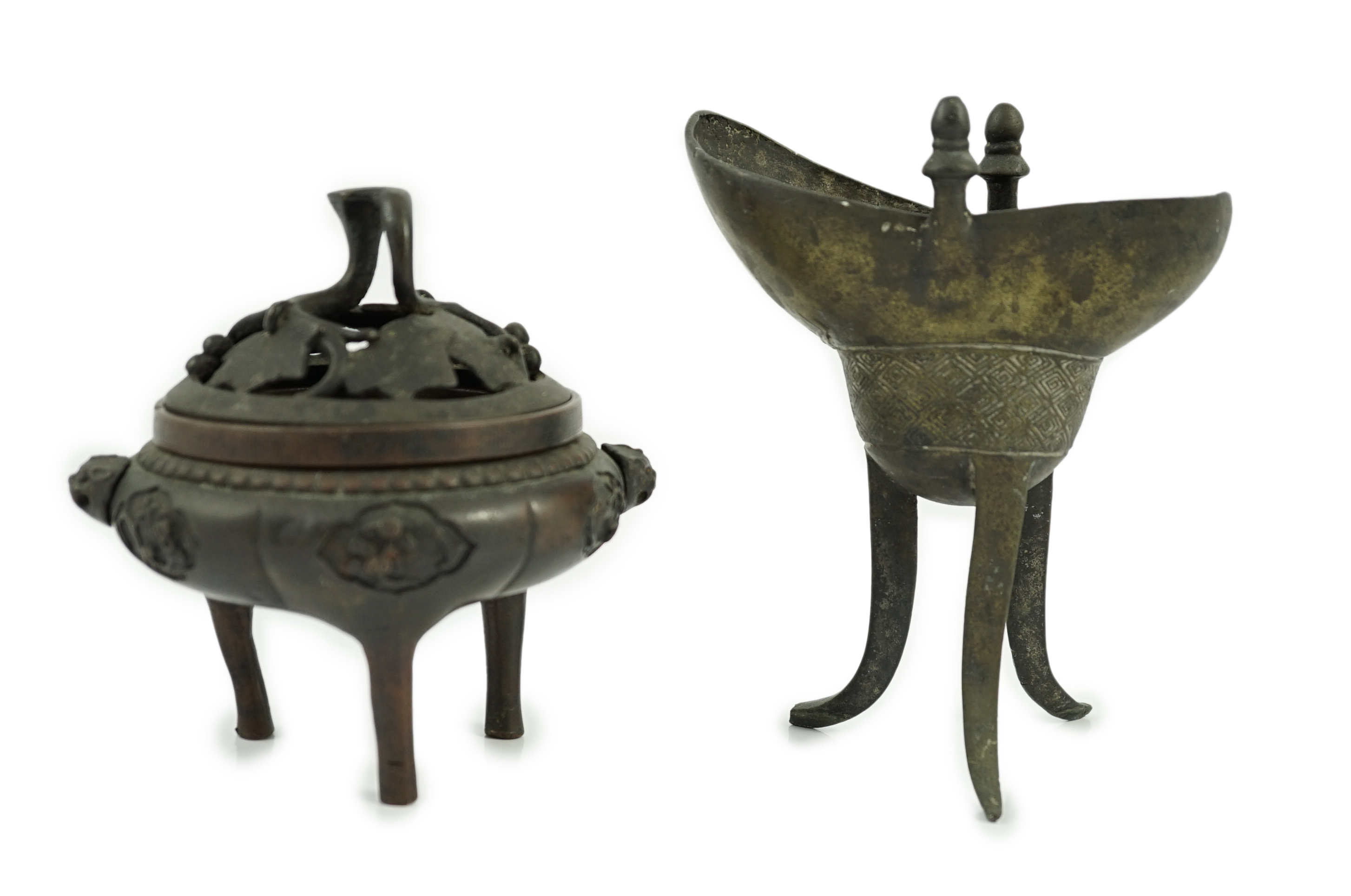 A Chinese bronze and copper alloy tripod censer and cover and a Chinese archaistic bronze tripod vessel, yi, both 17th century